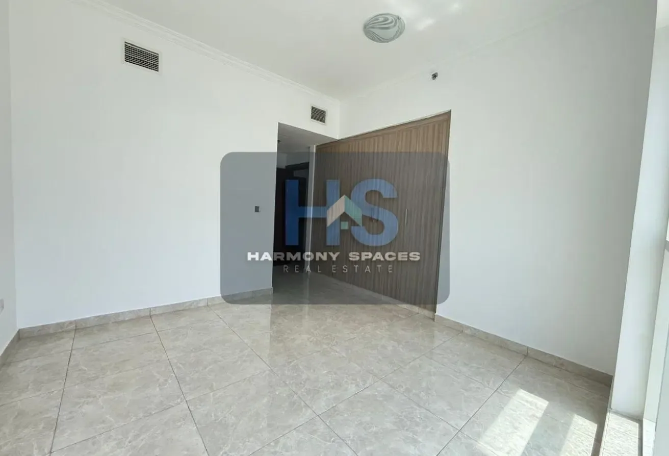 Neutral white walls | Community & road view | 2BR