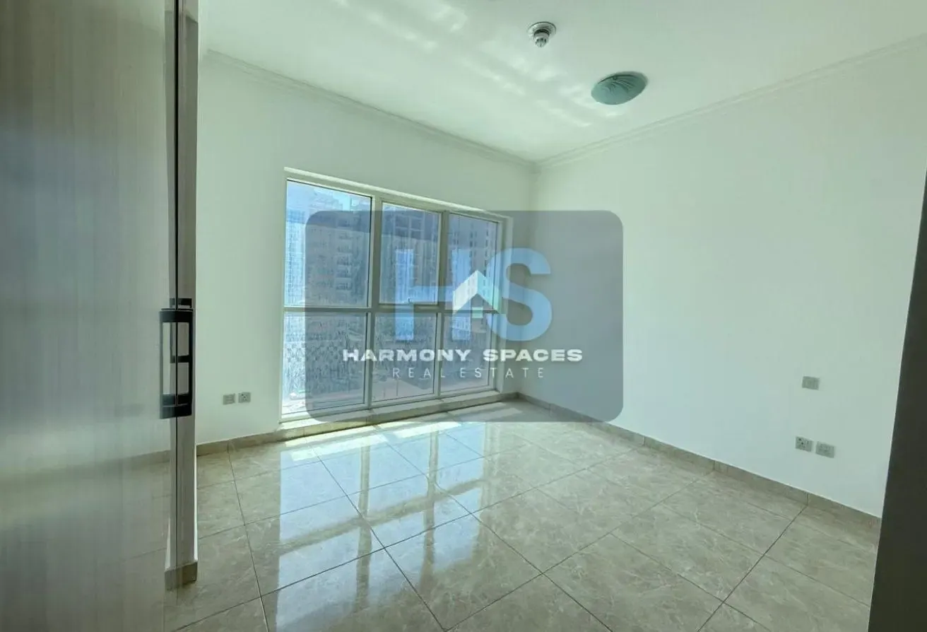 Neutral white walls | Community & road view | 2BR
