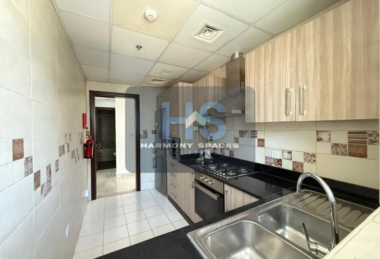 Neutral white walls | Community & road view | 2BR